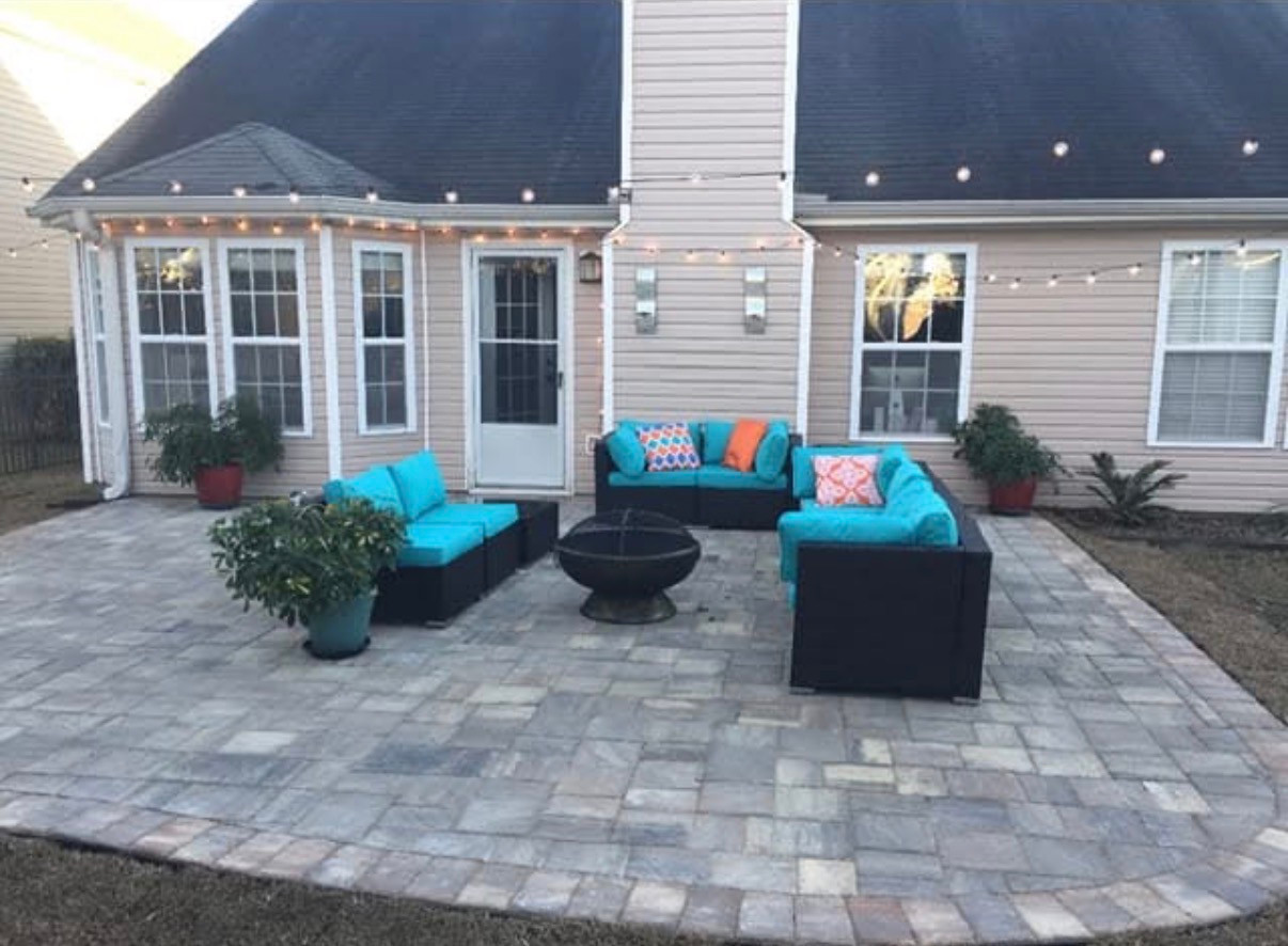 Paver patio with outdoor seating behind a Grand Strand home