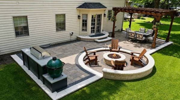 3D backyard rendering with a circular seating wall, grill and pergola